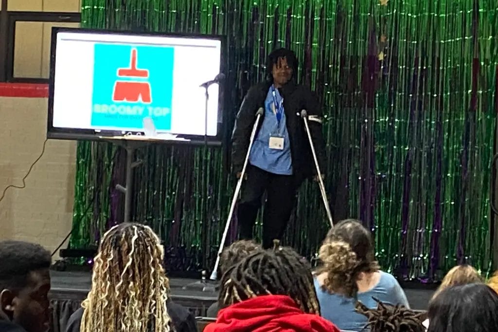 A young man proudly pitching his business idea at the Beyond School Partner of the Year Award presentation celebrating Lights On Afterschool
