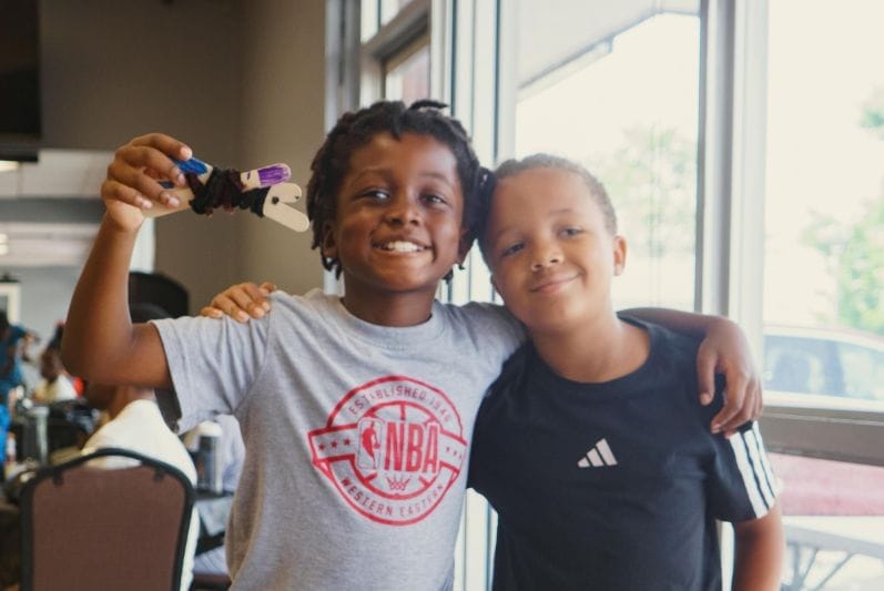 two young boys sharing their prototype