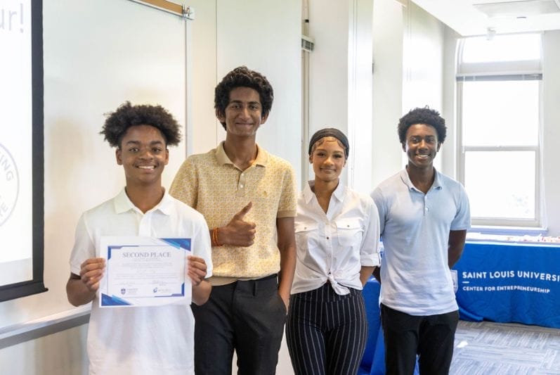 students proudly displaying certificate