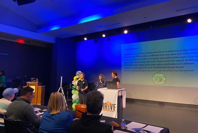 students on stage at a youth pitch competition