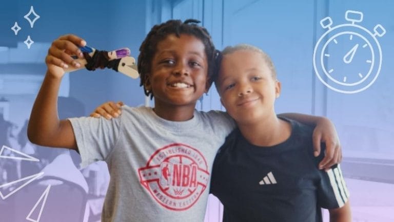 Two young boys proudly sharing their prototype image for Brain Breaks